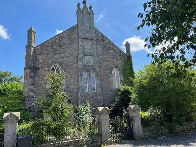 an old brick church with a fence in front of it at 4 Bed in Hereford oc-80464 in Glasbury