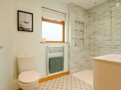 a bathroom with a toilet and a sink and a window at 2 Bed in Llandrindod Wells oc-89063 in Nantmel