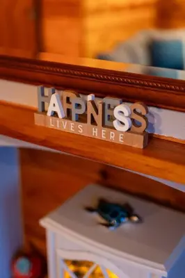 a wooden shelf with a sign that says arges lives here at Rural Log Cabin in Snowdonia near Coed y Brenin by Seren Short Stays in Ffestiniog
