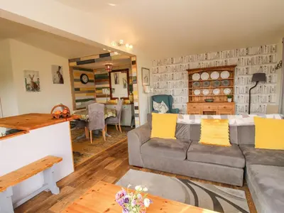 a living room with a couch and a table at Dragonfly Lodge in Shrewsbury