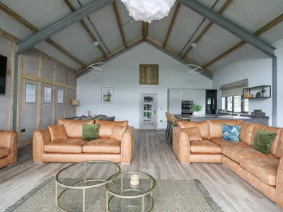 a living room with two couches and a table at Barcud Coch - Red Kite in Welshpool