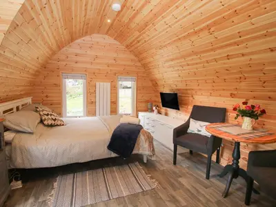 a bedroom with a bed and a desk and a television at The Pod in Shrewsbury