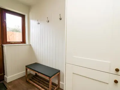 a small stool in a room with a drawer at Llygad Y Dydd in Bow Street