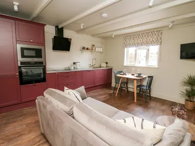 a living room with a couch and a table at Llygad Y Dydd in Bow Street