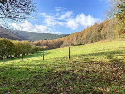 a field with a fence in the middle of a field at The Old Stables in Presteigne