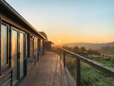 a balcony of a house with the sunset in the background at The Old Stables in Presteigne