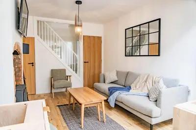 a living room with a couch and a table at Benyon Street Townhouse in Shrewsbury