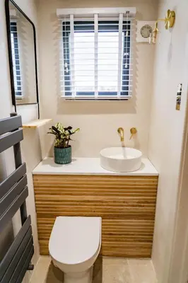 a bathroom with a toilet and a sink at Benyon Street Townhouse in Shrewsbury