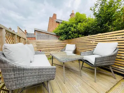 two chairs and a table on a patio at Benyon Street Townhouse in Shrewsbury