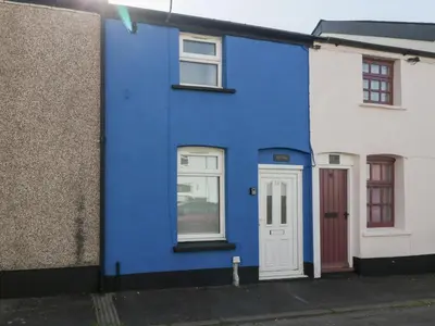 a blue house with a white door on a street at Rhif Deg in Brecon