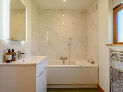 a white bathroom with a tub and a sink at 2 Bed in Llandrindod Wells oc-89064 in Nantmel