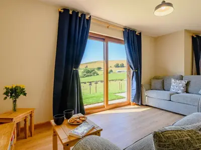 a living room with a couch and a large window at 2 Bed in Llandrindod Wells oc-89064 in Nantmel