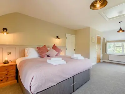 a bedroom with a large bed in a room at 4 Bed in Oswestry oc-87477 in Llansilin