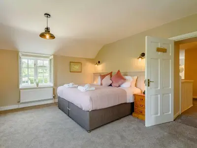 a bedroom with a large bed and a window at 4 Bed in Oswestry oc-87477 in Llansilin