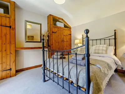 a bedroom with a bed and a mirror at 4 Bed in Hereford oc-44213 in Hereford