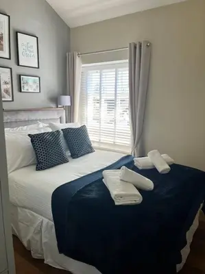 a bedroom with a large bed with towels on it at Isfryn, holiday home in Aberdyfi in Aberdyfi