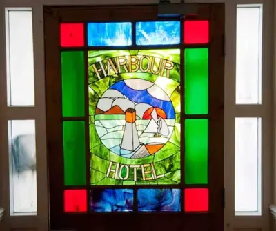 a stained glass window with the words harbourg hotel at The Penthouse Westhaven Aberdyfi in Aberdyfi