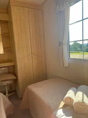 a small bedroom with a bed and a window at Heavenly Retreat in Lampeter