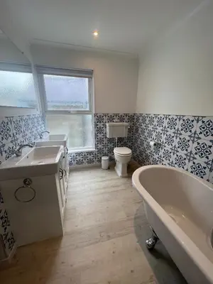 a bathroom with a tub and a sink and a toilet at Polruan - stunning central NQ house - dog friendly in New Quay
