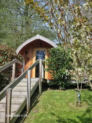 a small wooden cabin with a ramp leading to it at Mountain Edge Resort Mega pod 2 with Hot Tub in Church Stretton