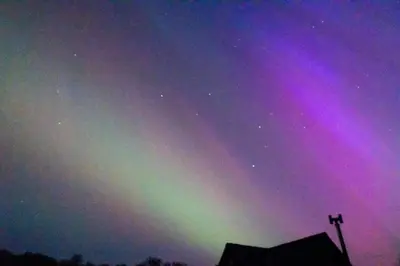 an aurora in the sky over a building at Pandy Farmhouse - Panoramic mountain views within Snowdonia's National Park - 4x4 Only in Dolgellau