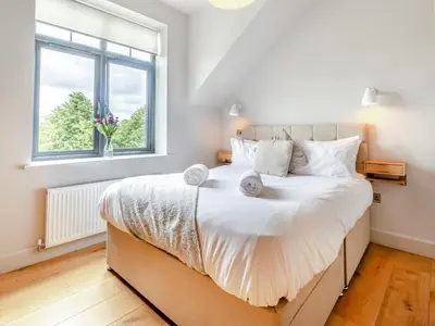 a bedroom with a large white bed with a window at 5 Bed in Llanymynech oc-80686 in Llanymynech