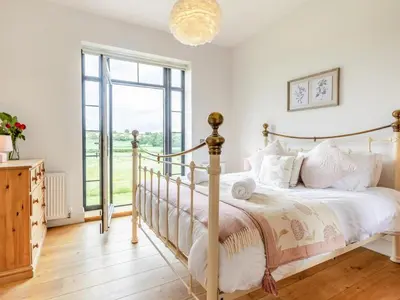 a bedroom with a bed and a large window at 5 Bed in Llanymynech oc-80686 in Llanymynech