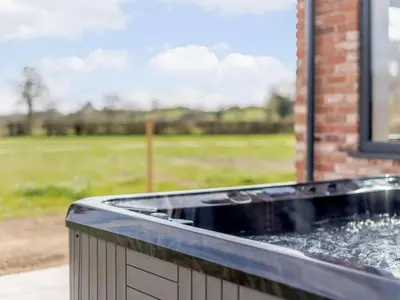 a water fountain in front of a brick building at 5 Bed in Llanymynech oc-80686 in Llanymynech