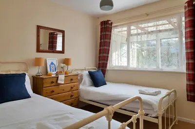 a bedroom with two beds and a window at Finest Retreats - 37 Bro Enddwyn in Dyffryn