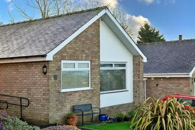 a brick house with a white at Finest Retreats - 37 Bro Enddwyn in Dyffryn