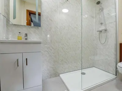 a bathroom with a shower and a toilet and a sink at 1 Bed in Dyffryn Ardudwy oc-89777 in Dyffryn