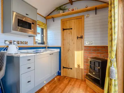 a kitchen with white cabinets and a stove at 1 Bed in Rhayader oc-90278 in Saint Harmon
