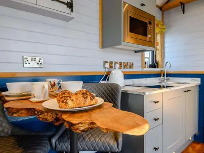 a table with a plate of food on it in a kitchen at 1 Bed in Rhayader oc-90278 in Saint Harmon