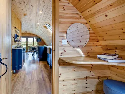 a room with a wooden ceiling with a circular mirror at 2 Bed in Rhayader oc-90276 in Saint Harmon
