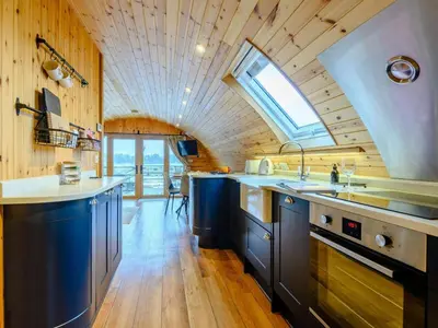 a kitchen with blue cabinets and a skylight at 2 Bed in Rhayader oc-90274 in Saint Harmon