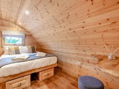 a bedroom in a log cabin with a bed at 2 Bed in Rhayader oc-90279 in Saint Harmon