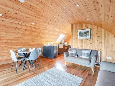 a living room with a table and chairs and wooden walls at 2 Bed in Rhayader oc-90279 in Saint Harmon