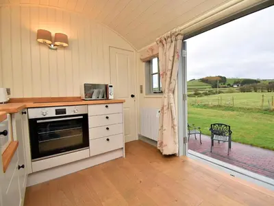 a kitchen with a stove and a large window at 1 Bed in Rhayader oc-90277 in Saint Harmon