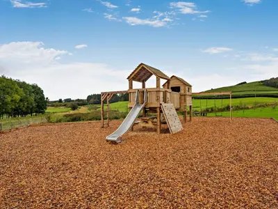 a playground with a slide in a gravel field at 1 Bed in Rhayader oc-90284 in Saint Harmon