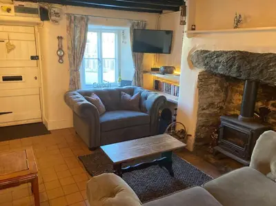 a living room with a couch and a fireplace at Lovely peaceful 2 bed cottage in Llandderfel