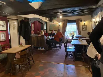 a group of people sitting at tables in a restaurant at Lovely peaceful 2 bed cottage in Llandderfel