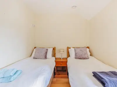 two twin beds in a room with white walls at 3 Bed in Corwen oc-90459 in Corwen