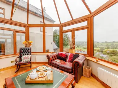 a living room with a couch and a table at 3 Bed in Corwen oc-90459 in Corwen