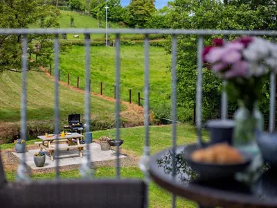 a view of a garden with a table and a bench at 1 Bed in Church Stretton oc-90929 in All Stretton
