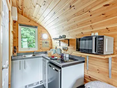 a kitchen in a tiny house with a microwave and a stove at 1 Bed in Church Stretton oc-90929 in All Stretton