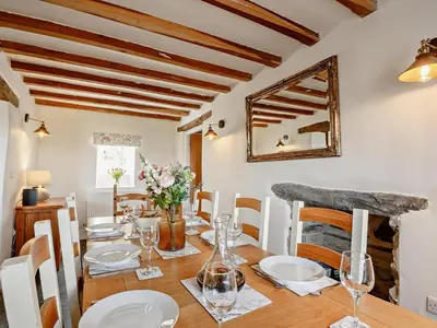 a dining room with a table and a mirror at 6 Bed in Harlech oc-91546 in Harlech