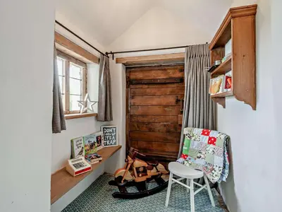 a room with a wooden door and a chair at 4 Bed in Hereford oc-92039 in Clyro