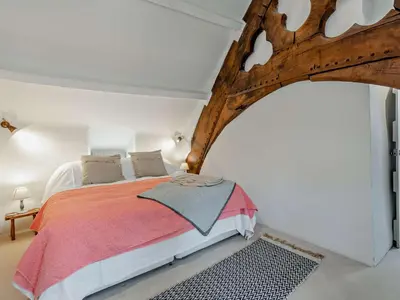 a bedroom with a large bed in a white room at 4 Bed in Hereford oc-92039 in Clyro