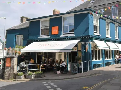 a blue building with people sitting outside of it at 4 Bed in Hereford oc-92039 in Clyro