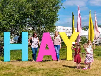 a group of children standing in front of a sign that reads happy at 4 Bed in Hereford oc-92039 in Clyro